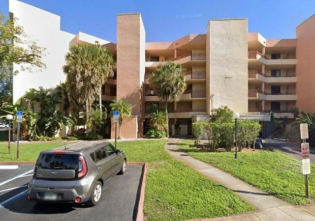 a view of a cars park in front of a building