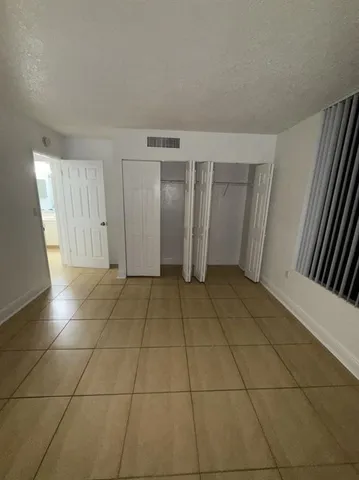 a view of a livingroom with an empty space and a window