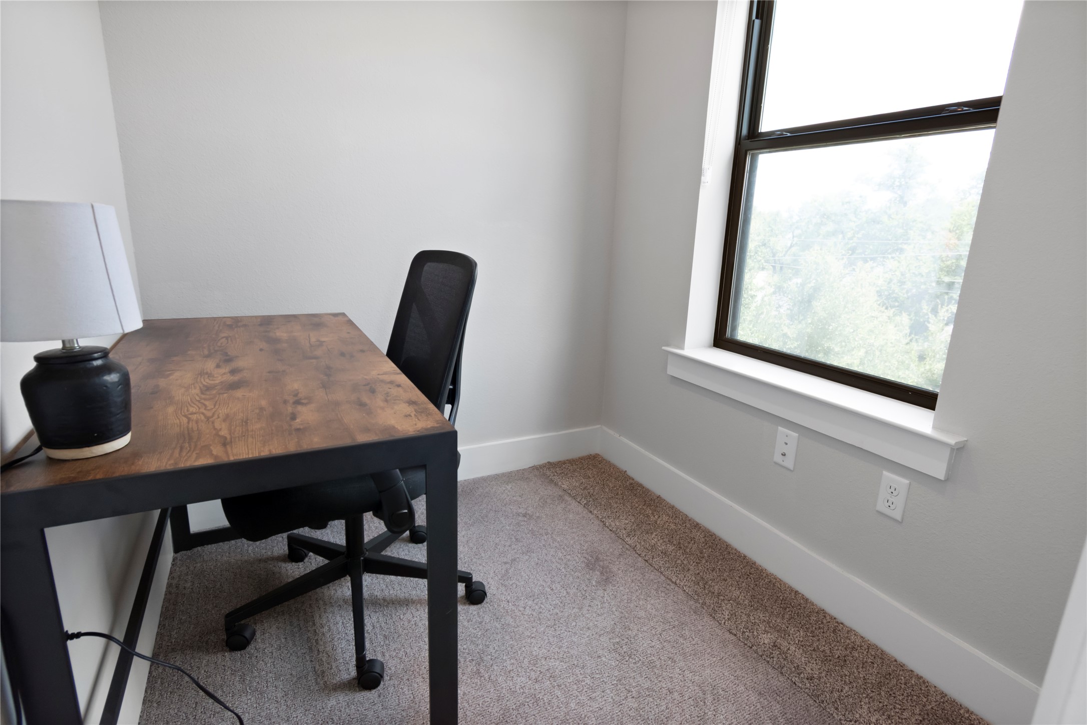 13309 Morris Road, Unit 62 Austin, TX 78729 - Photo 17 of 21 A quiet dedicated workspace features a window with natural illumination and soft carpeted flooring.