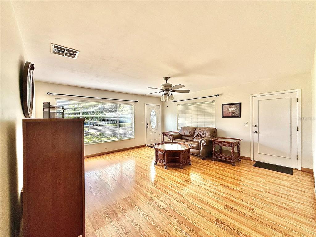 210 14th Avenue Southwest Largo, FL 33770 - Photo 3 of 8 a living room with furniture and a wooden floor