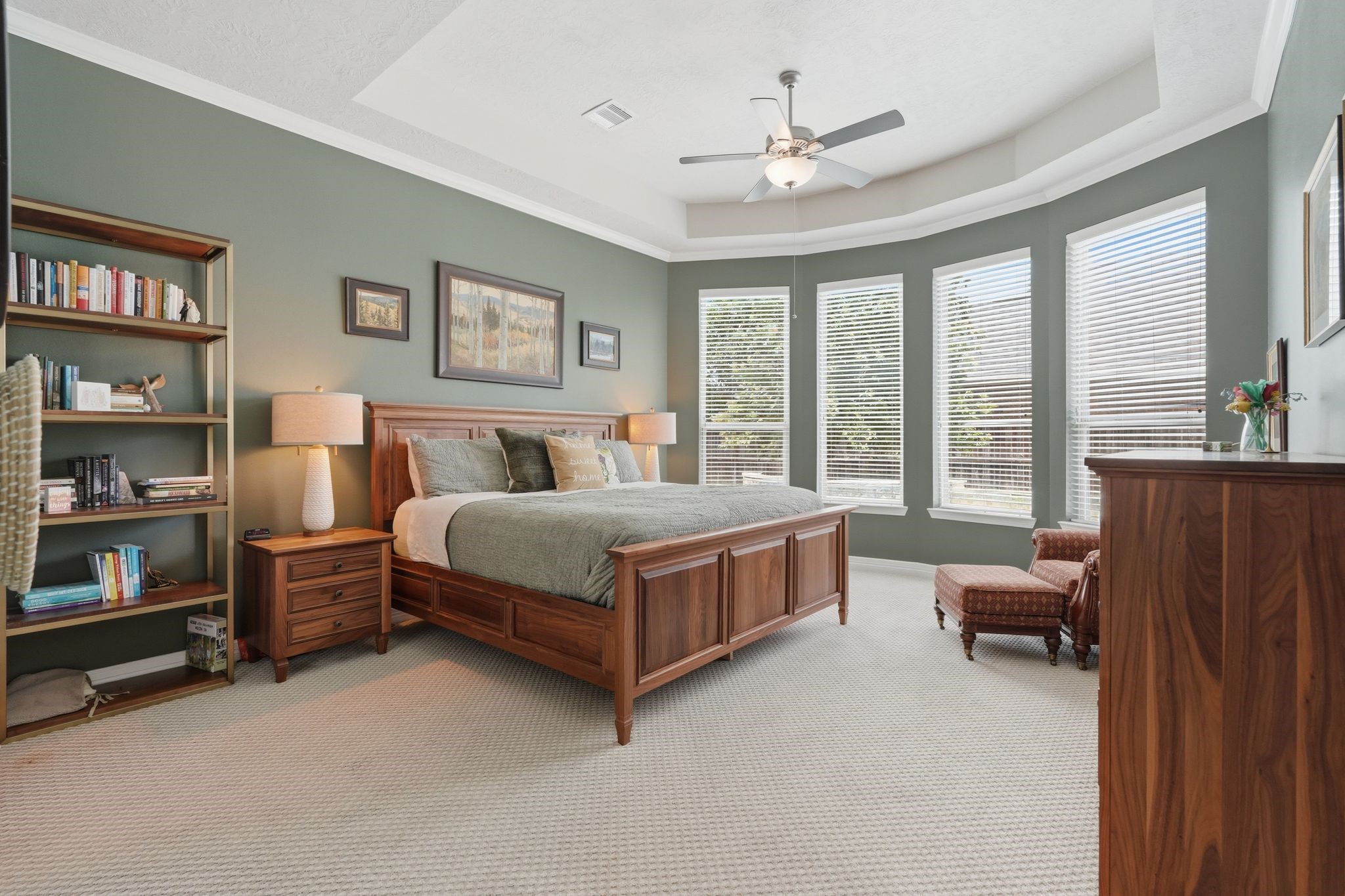 27705 South Slate Hills Lane Spring, TX 77386 - Photo 16 of 45 Luxurious primary suite with a deep tray ceiling and a large wall of windows overlooking the grounds.