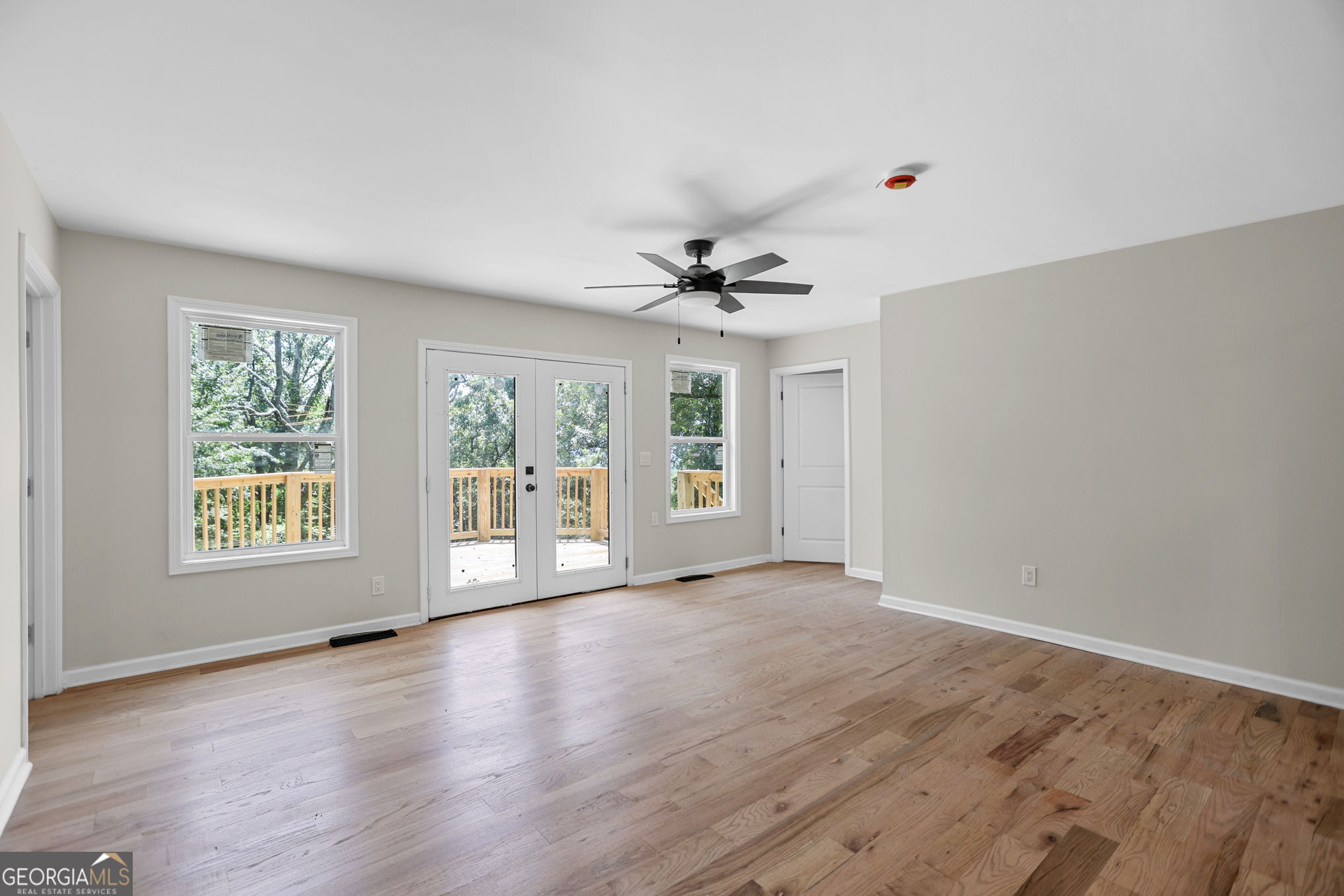 7060 Scenic Heights Road Manchester, GA 31816 - Photo 28 of 52 a view of an empty room with a window and wooden floor