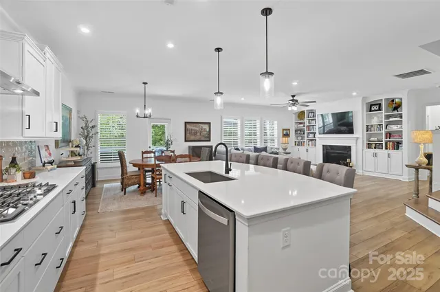 a large kitchen with stainless steel appliances granite countertop a stove and kitchen island