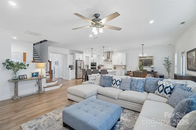 a living room with furniture and kitchen view