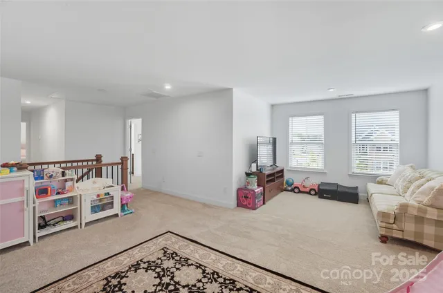 a bedroom with furniture and a large window
