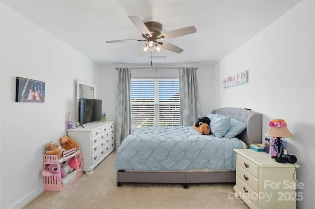 a bedroom with bed and a chandelier