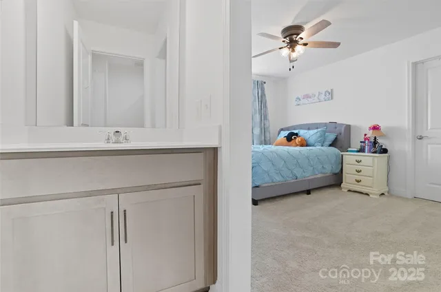a en suite bathroom with a double vanity sink and a mirror