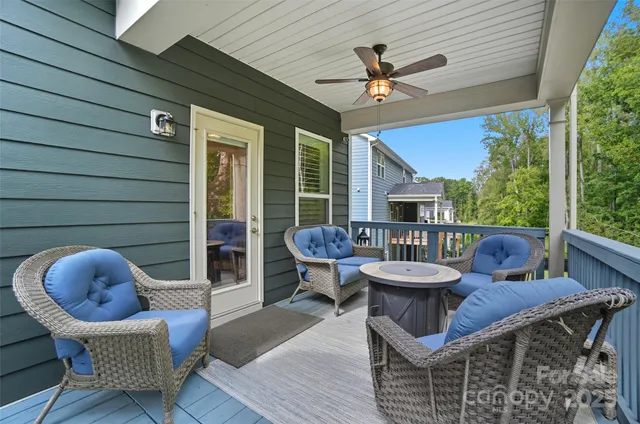 a balcony with furniture and a large window