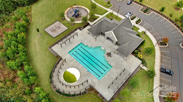 an aerial view of a house with outdoor space and a lake view