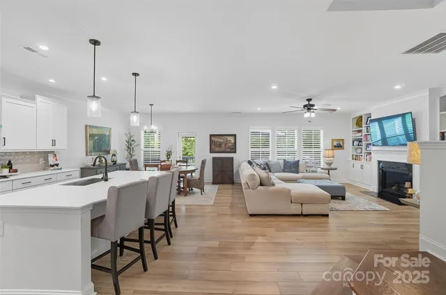 a living room with fireplace furniture and a wooden floor