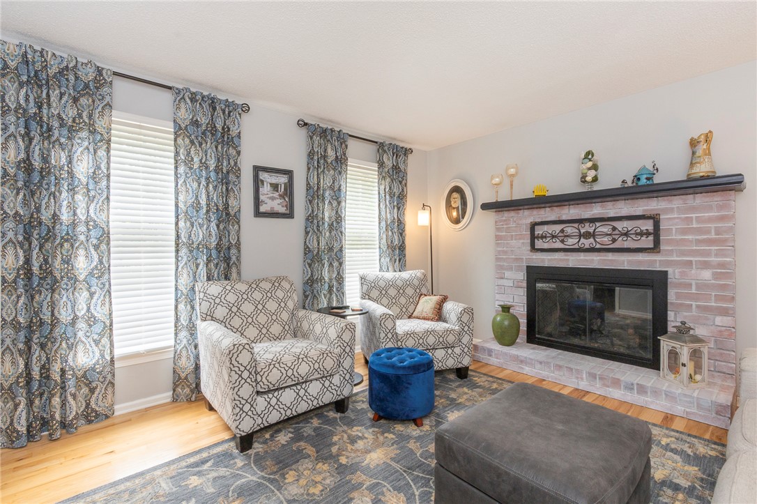 203 Oak Hollow Pendleton, SC 29670 - Photo 6 of 50 Hardwood floors and a brick fireplace create a cozy and inviting gathering space.