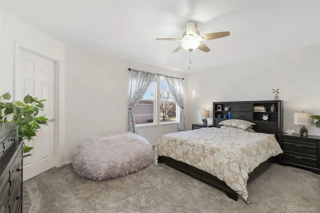 a bedroom with a bed and a potted plant