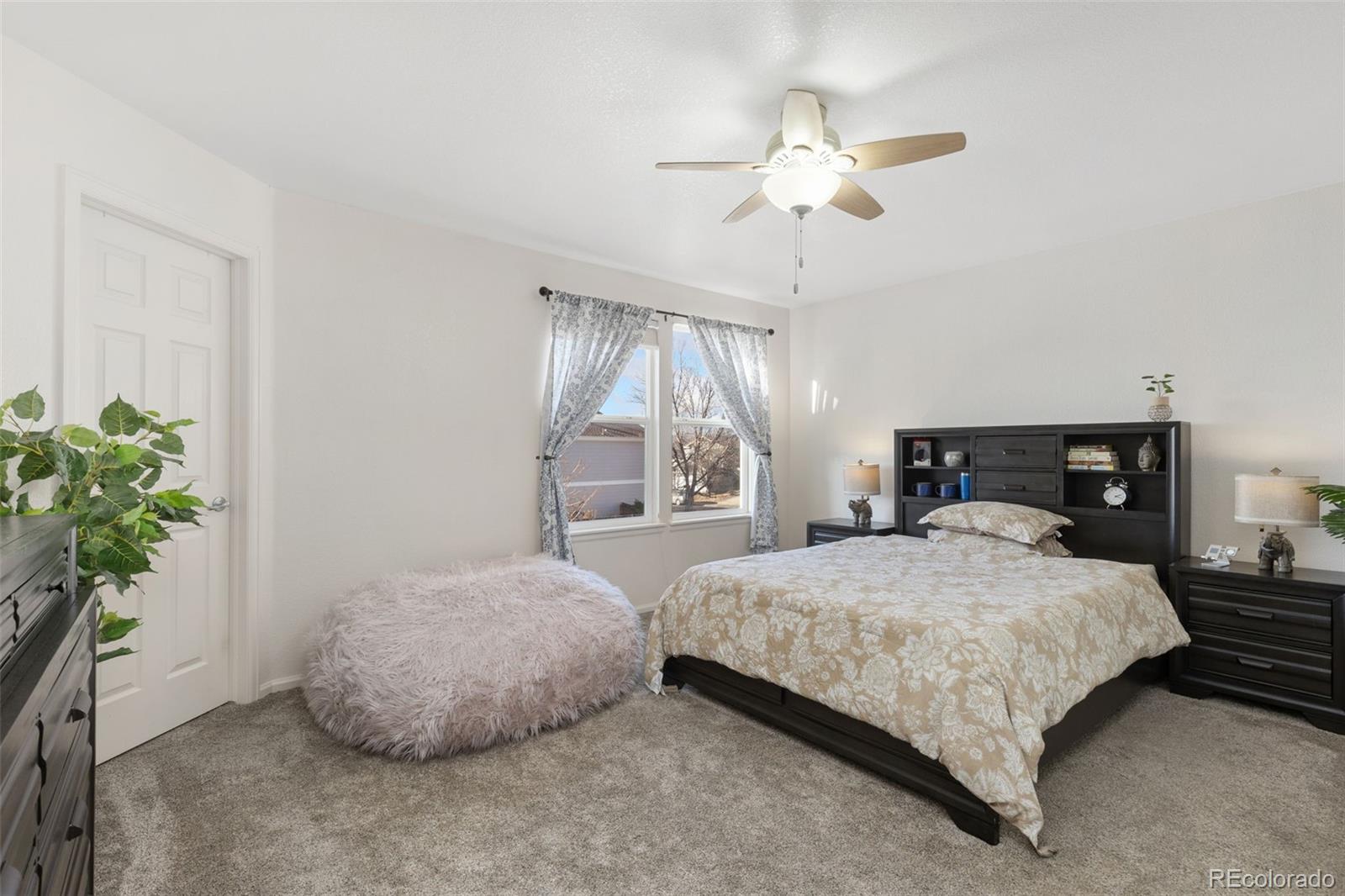 10696 Upper Ridge Road Longmont, CO 80504 - Photo 11 of 25 a bedroom with a bed and a potted plant