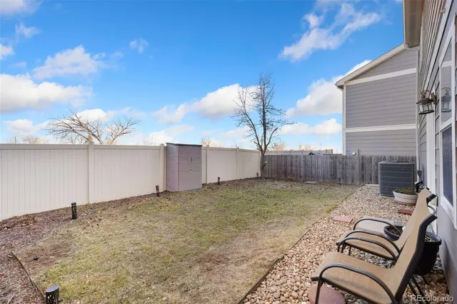 a backyard of a house with table and chairs