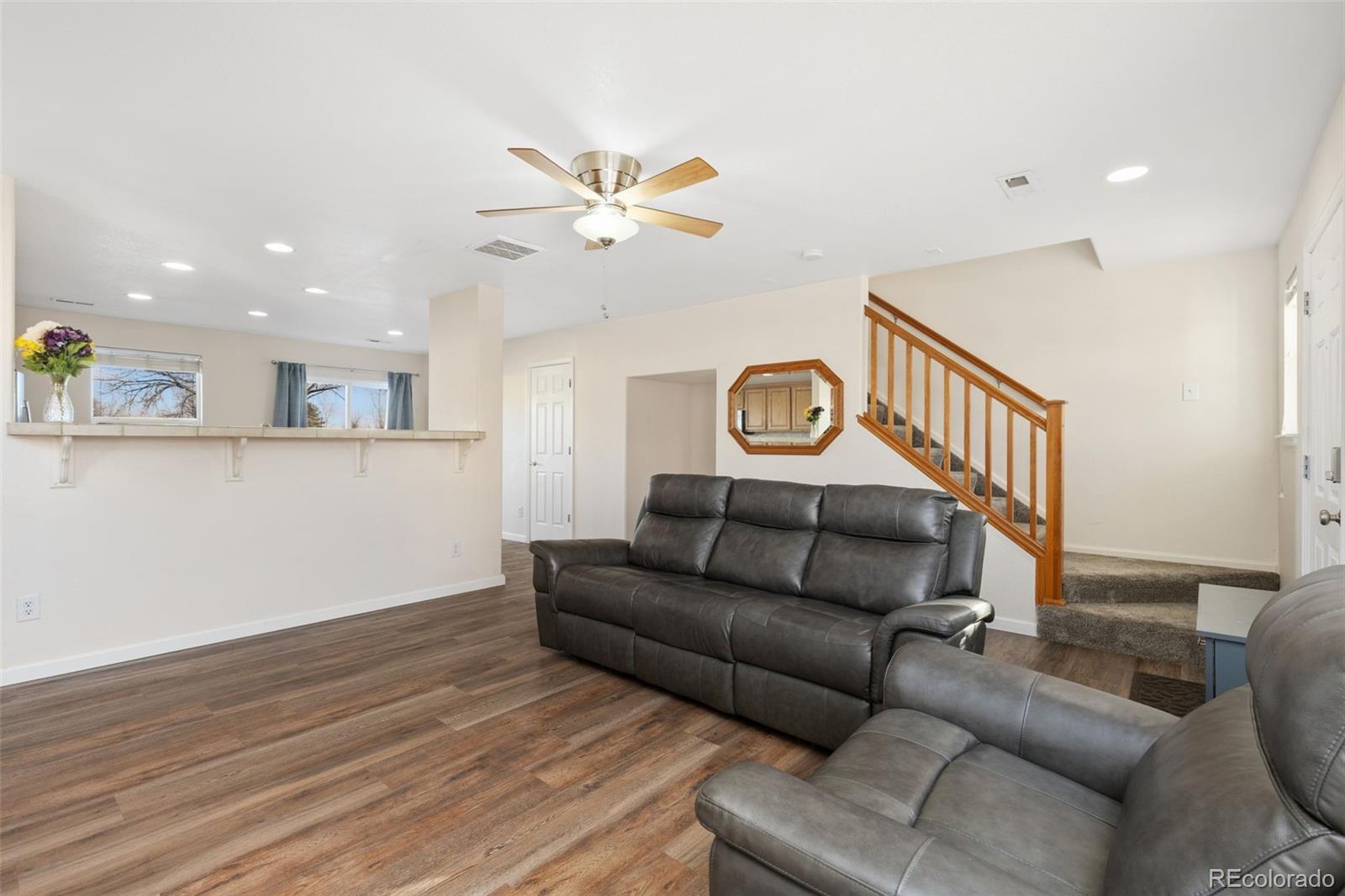 10696 Upper Ridge Road Longmont, CO 80504 - Photo 5 of 25 a living room with furniture and a wooden floor