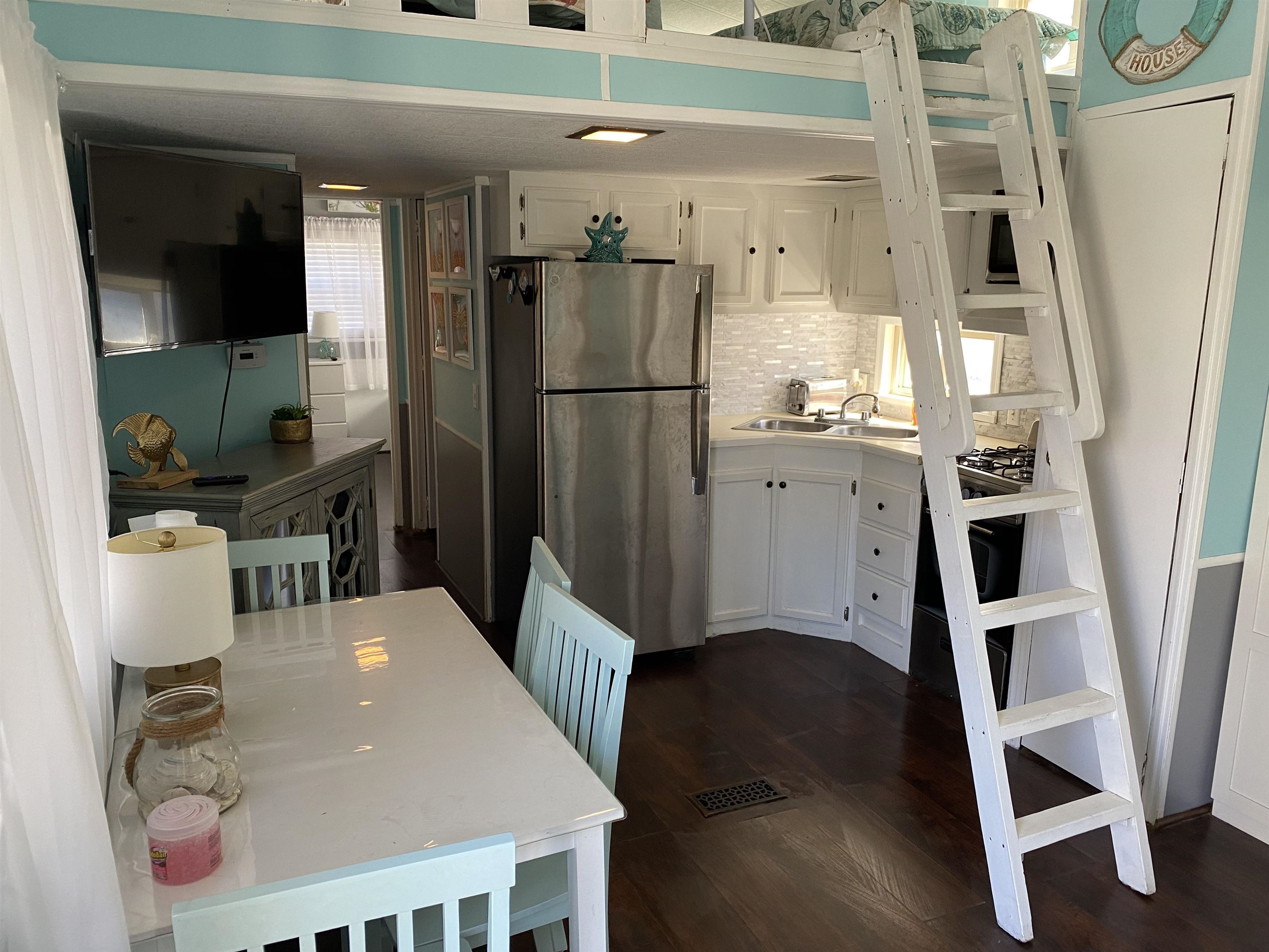 515 Corsons Tavern Road Ocean View, NJ 08230 - Photo 5 of 18 a kitchen with stainless steel appliances granite countertop a refrigerator a microwave oven a sink and dishwasher