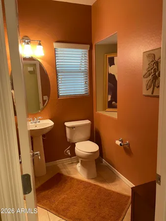 a bathroom with a toilet a sink a mirror a shower and vanity