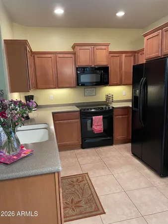 a kitchen with stainless steel appliances granite countertop a sink dishwasher stove top oven and refrigerator