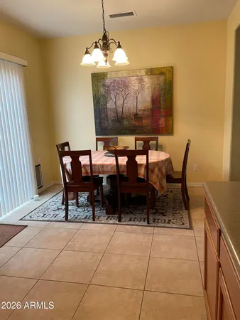 a view of a dining room with furniture and chandelier