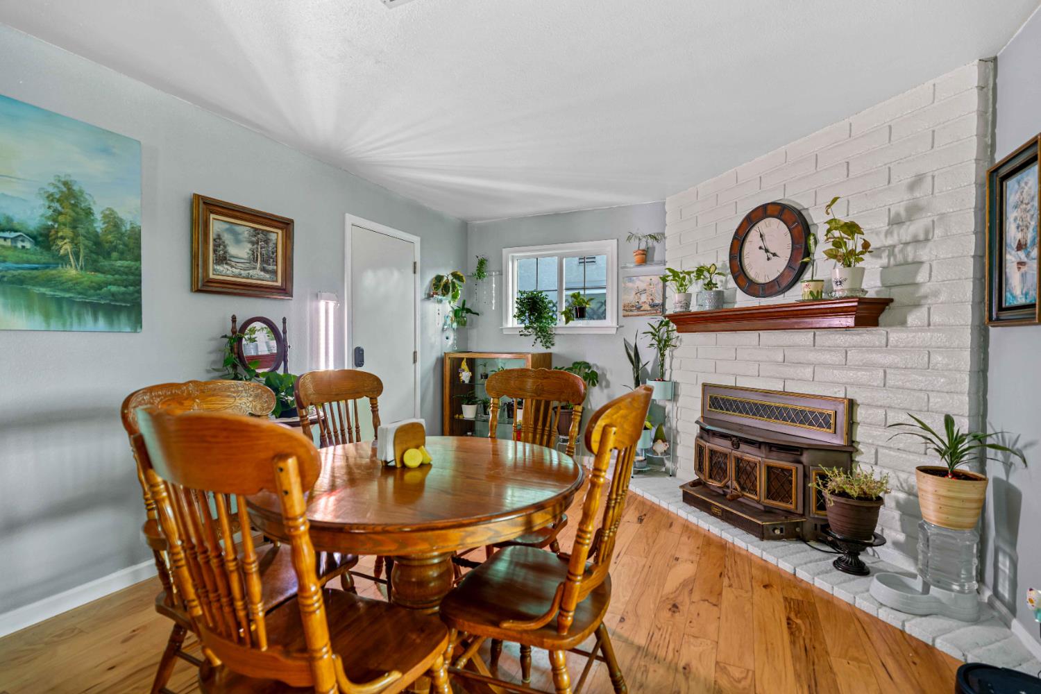 3913 Peacock Lane Modesto, CA 95356 - Photo 7 of 21 a dining room with furniture and a fireplace