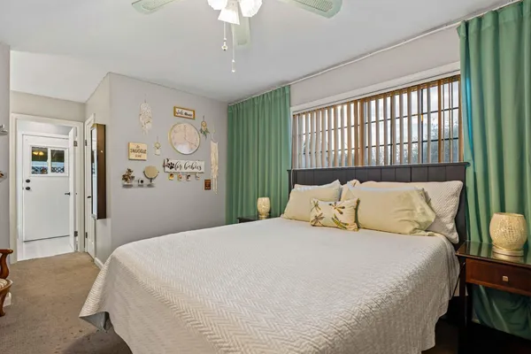 a bedroom with a large bed and a window