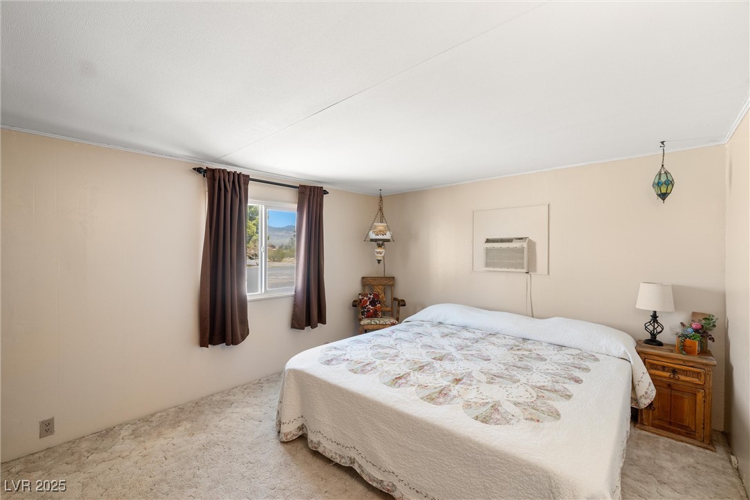 101 West Pechstein Road Pahrump, NV 89060 - Photo 21 of 33 Primary bedroom has an ensuite with tiled shower and a walkin closet.