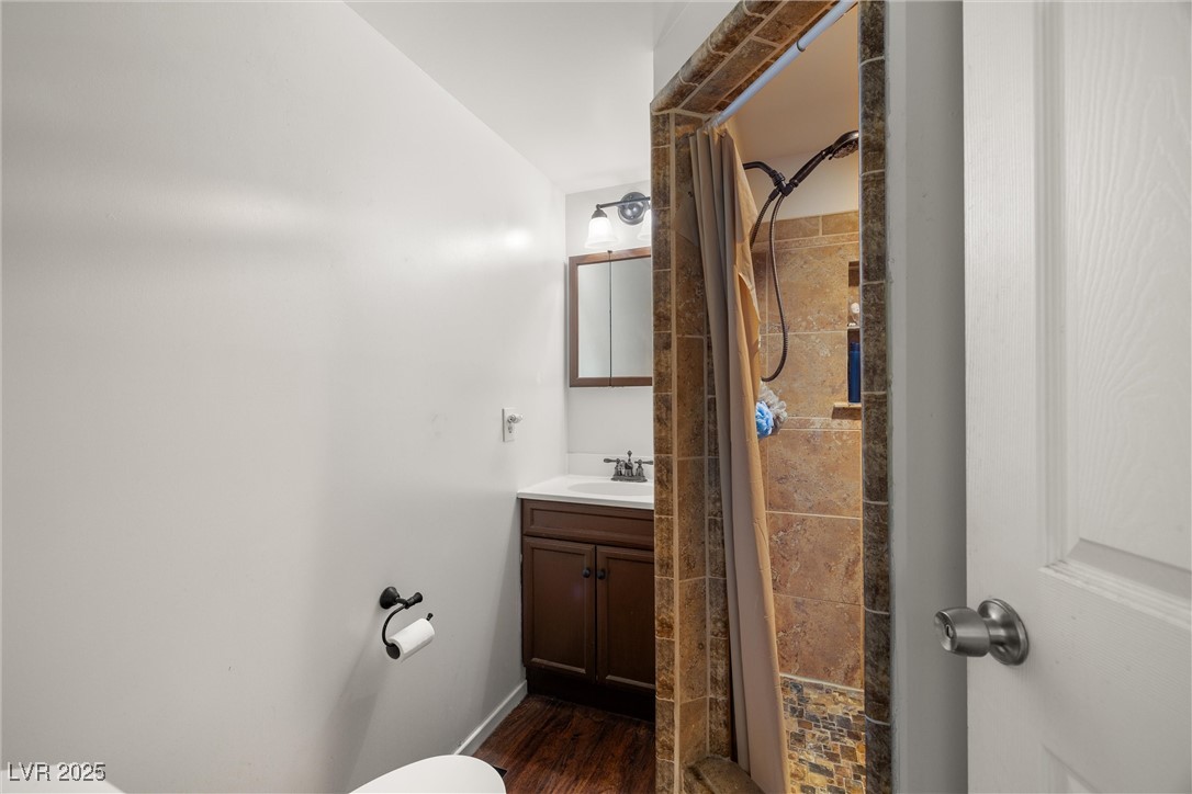 101 West Pechstein Road Pahrump, NV 89060 - Photo 22 of 33 Primary bathroom featuring wood finished floors, toilet, and vanity.