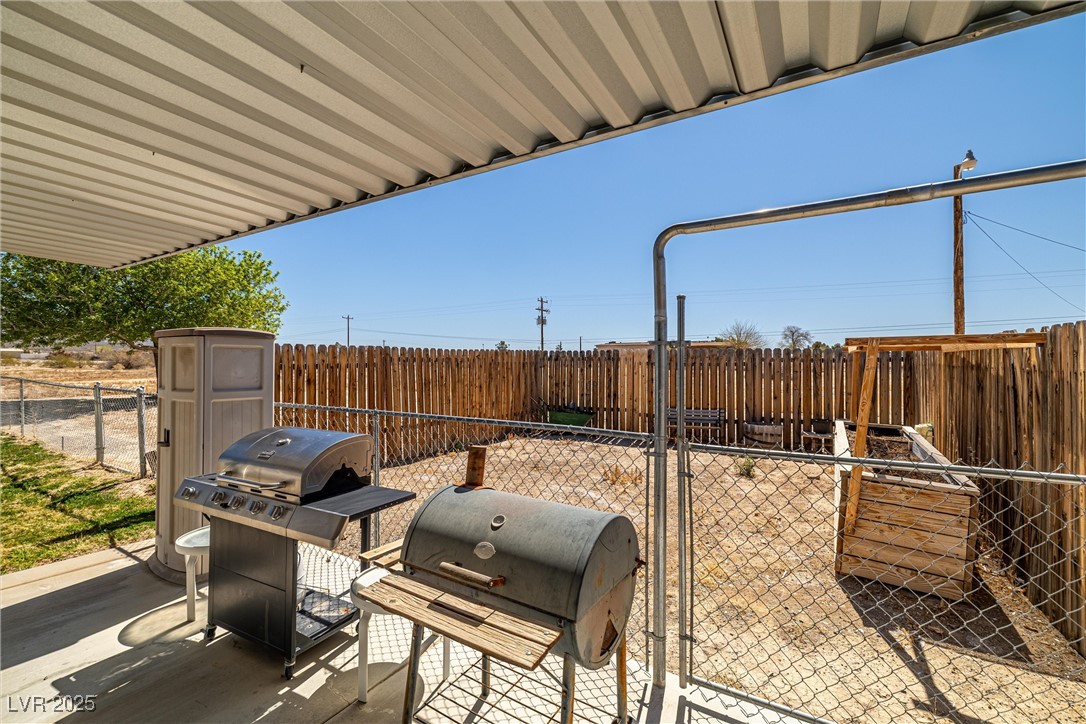 101 West Pechstein Road Pahrump, NV 89060 - Photo 25 of 33 View of patio with a fenced backyard and grilling area
