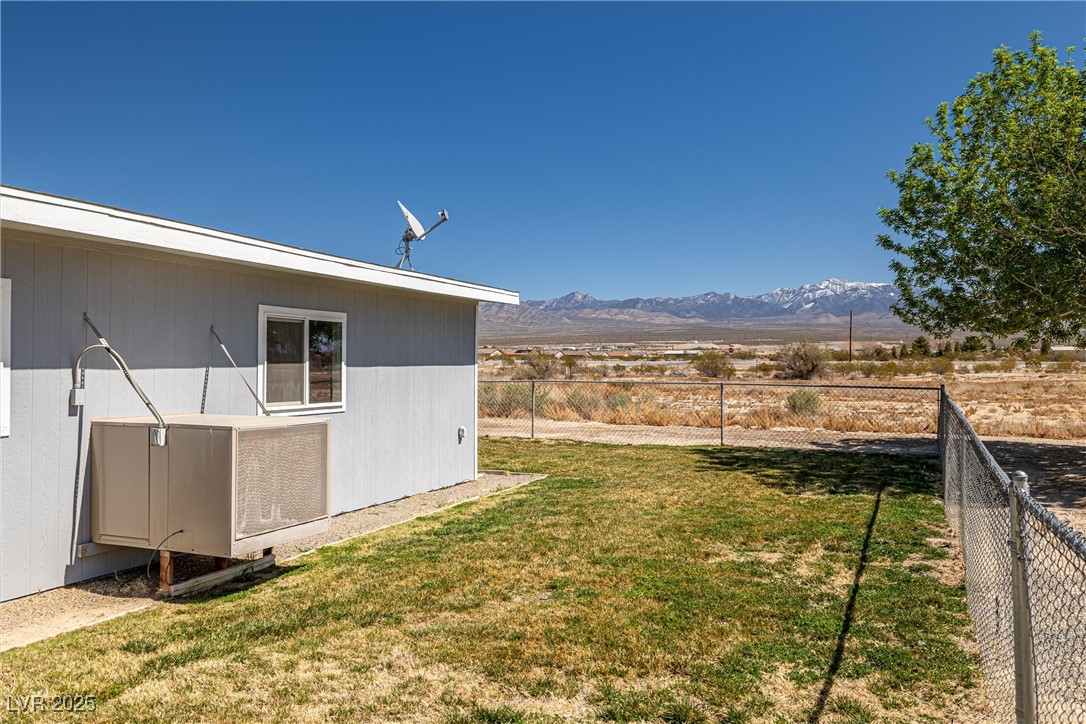 101 West Pechstein Road Pahrump, NV 89060 - Photo 27 of 33 View of yard with a mountain view of Mount Charleston and a fenced backyard
