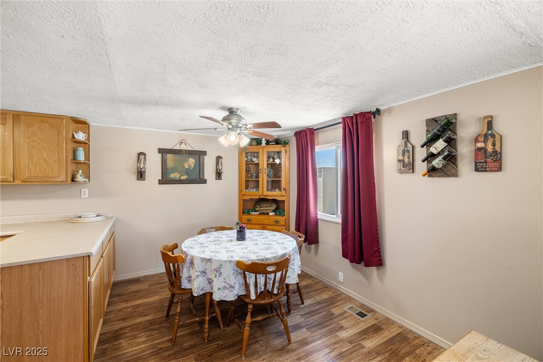 101 West Pechstein Road Pahrump, NV 89060 - Photo 8 of 33 Dining space with wood finished floors and ceiling fan.
