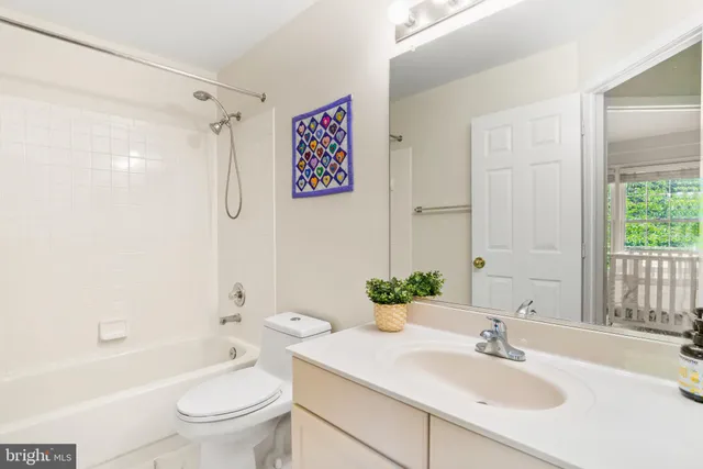 a bathroom with a sink toilet tub and shower