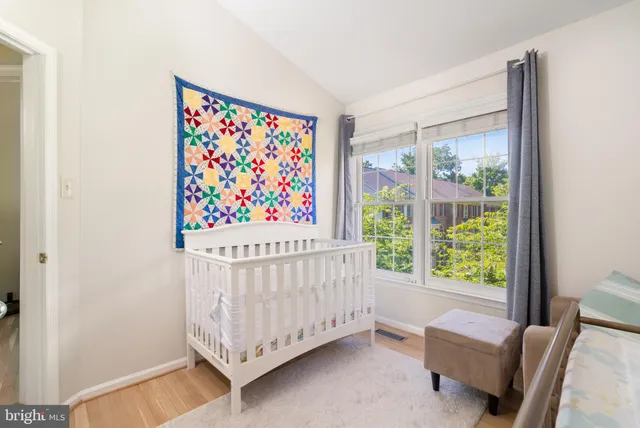 a bed sitting in a bedroom next to a window