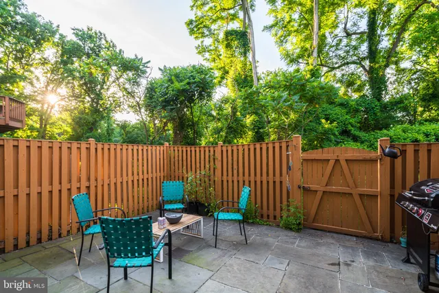 a backyard of a house with barbeque oven and outdoor seating