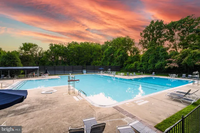 a view of a swimming pool with a lounge chair
