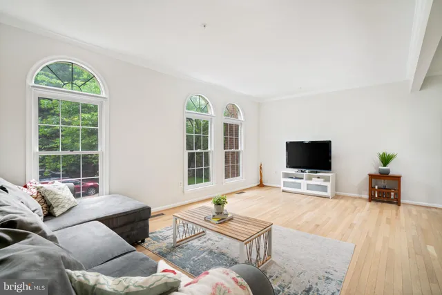 a living room with furniture a window and a flat screen tv