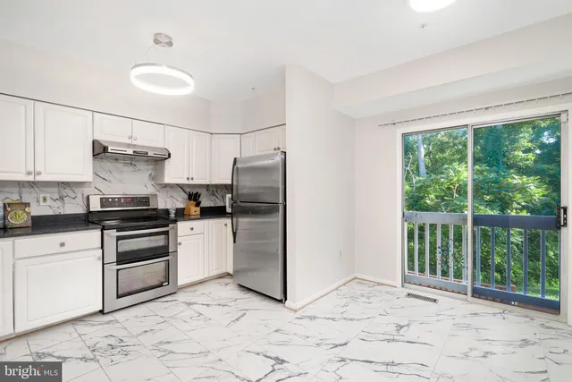 a kitchen with a refrigerator and a stove