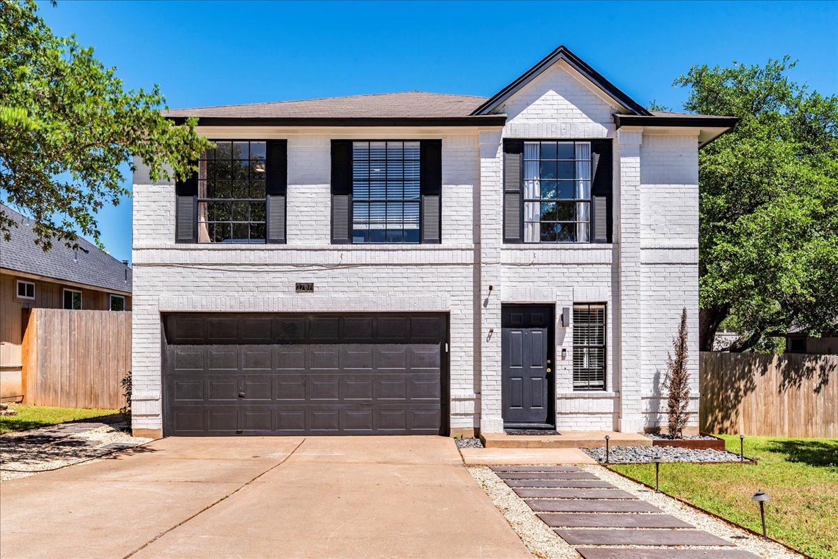 1707 Yucca Lane Cedar Park, TX 78613 - Photo 1 of 26 a front view of a house with a yard and garage