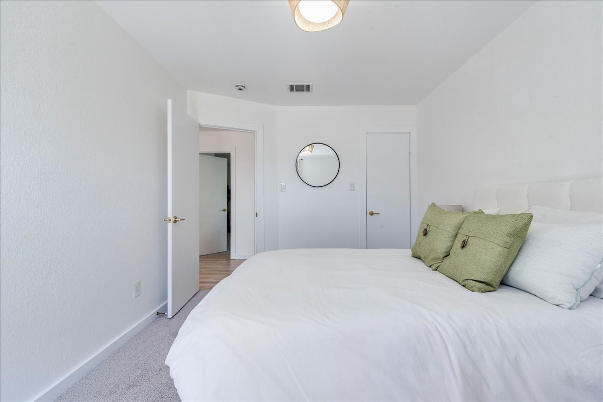 1707 Yucca Lane Cedar Park, TX 78613 - Photo 18 of 26 a bedroom with a bed and wooden floor