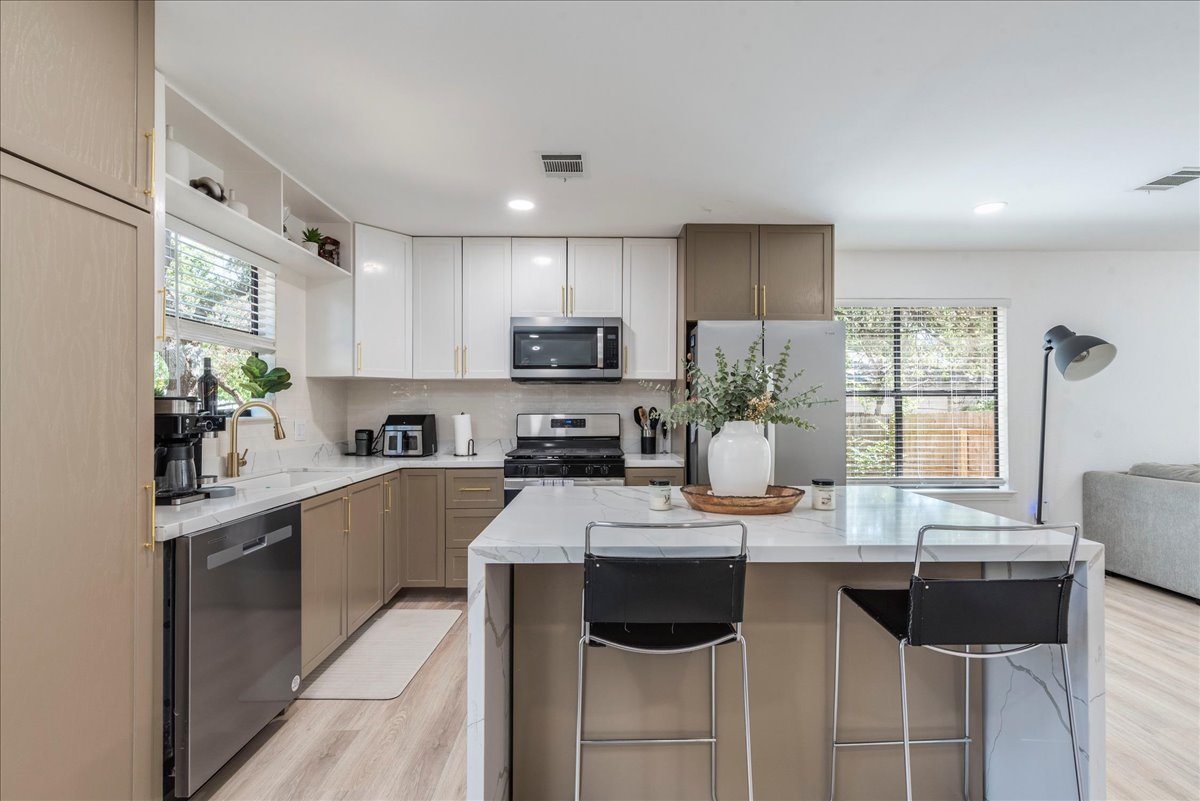 1707 Yucca Lane Cedar Park, TX 78613 - Photo 7 of 26 a kitchen with a counter top space appliances and a window