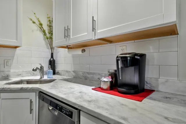a kitchen with a sink and wooden cabinets