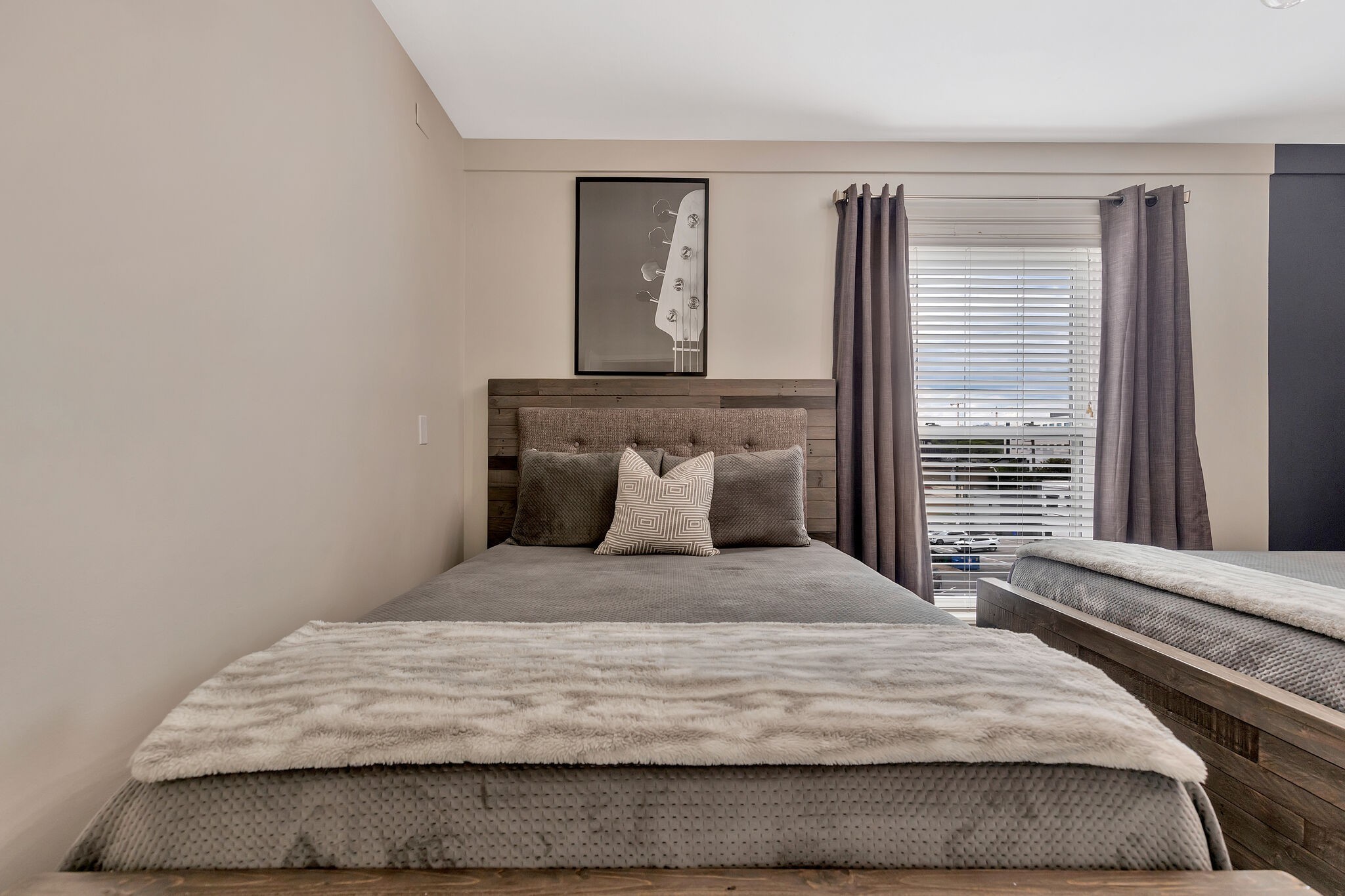 11 Music Square East, Unit 203 Nashville, TN 37203 - Photo 13 of 26 a large bed sitting in a bedroom next to a window