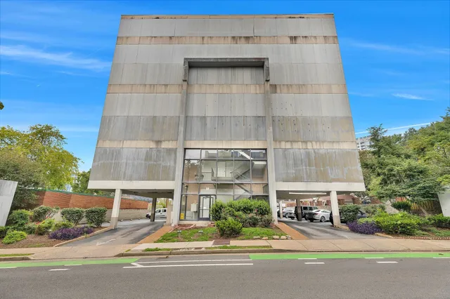 a building with a street sign on the side of it
