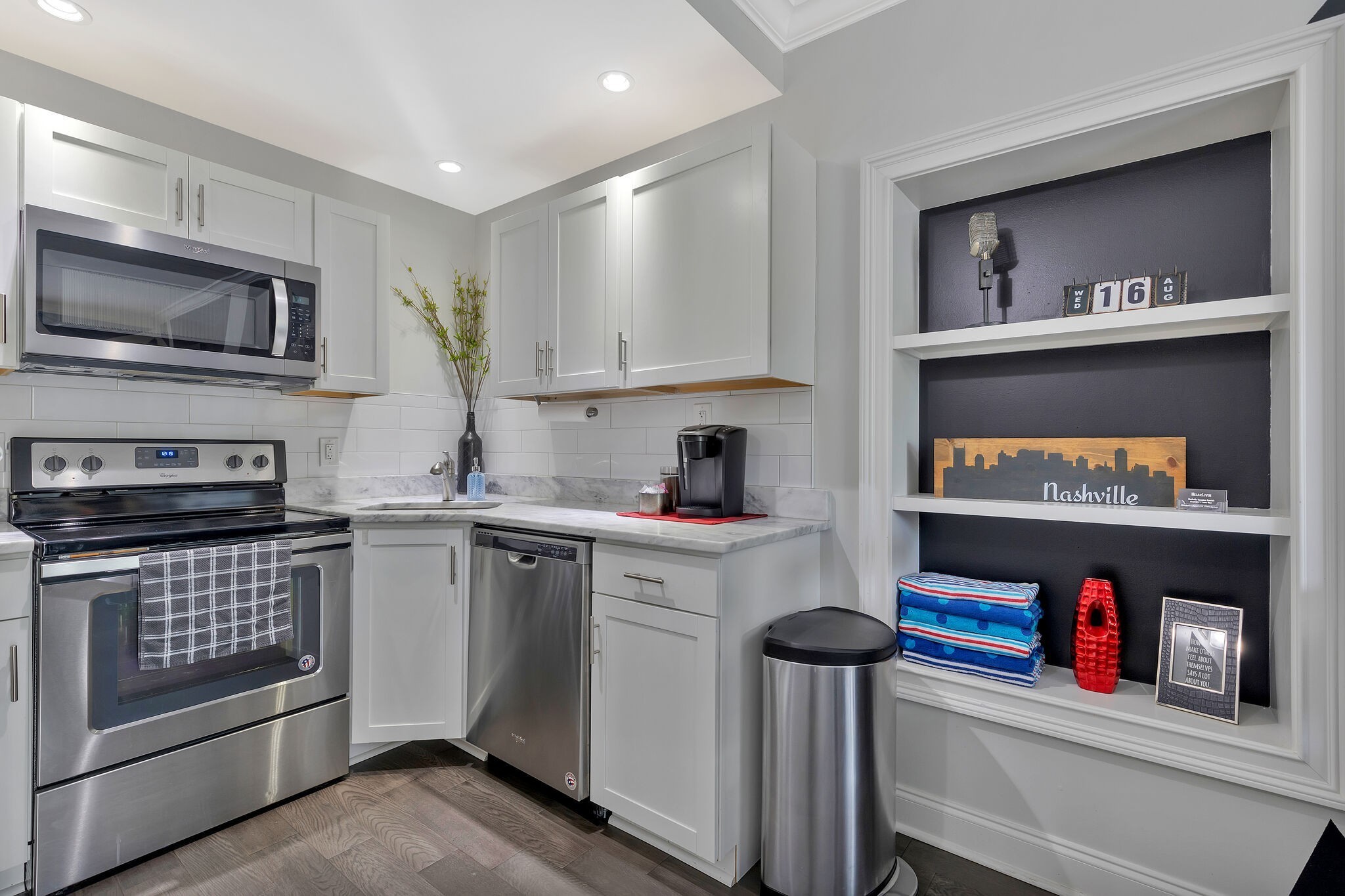 11 Music Square East, Unit 203 Nashville, TN 37203 - Photo 7 of 26 a kitchen with granite countertop lots of clutter and stainless steel appliances