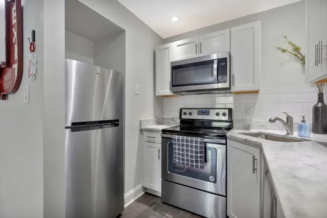 a kitchen with a refrigerator stove and microwave