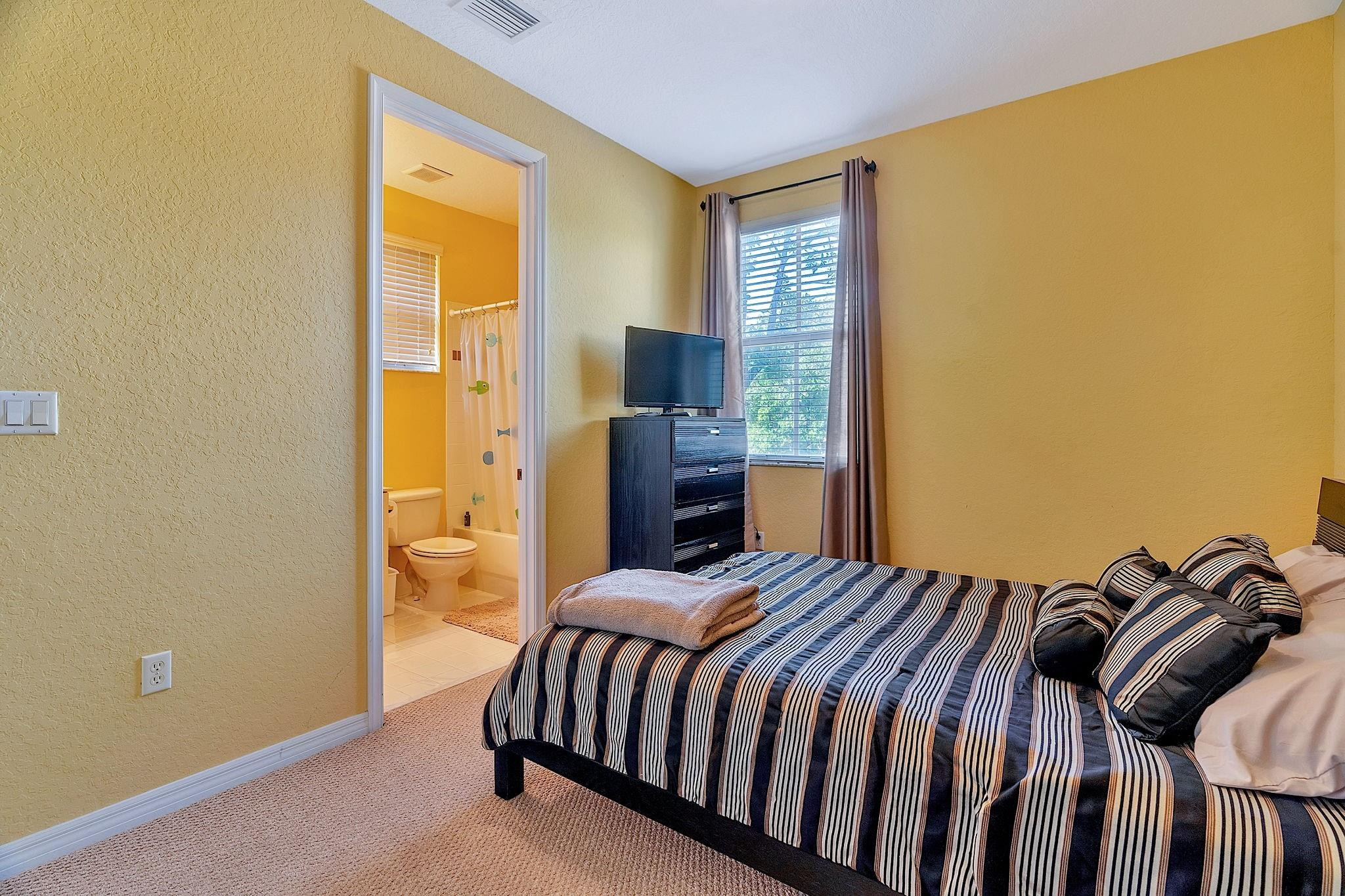 2851 Prospect Road, Unit 1101 Tamarac, FL 33309 - Photo 33 of 49 a bedroom with a bed and wooden floor