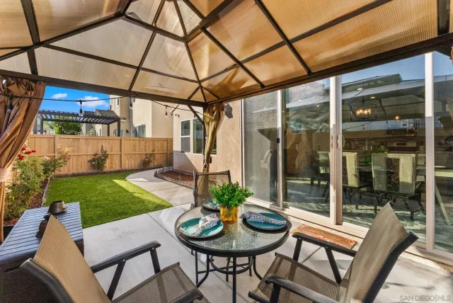 a view of a patio with a table and chairs