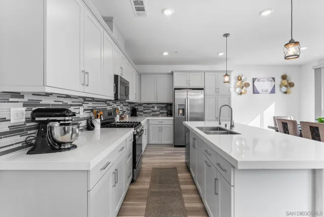 a kitchen with a sink stove and cabinets