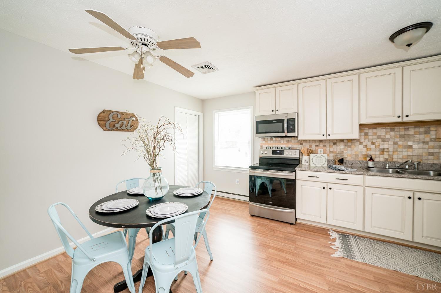 1164 English Tavern Road Rustburg, VA 24588 - Photo 11 of 46 a kitchen with granite countertop white cabinets and stainless steel appliances