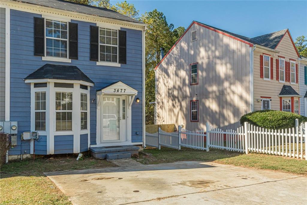 3477 Kingswood Trail Decatur, GA 30034 - Photo 18 of 44 a view of a brick house with many windows next to a road