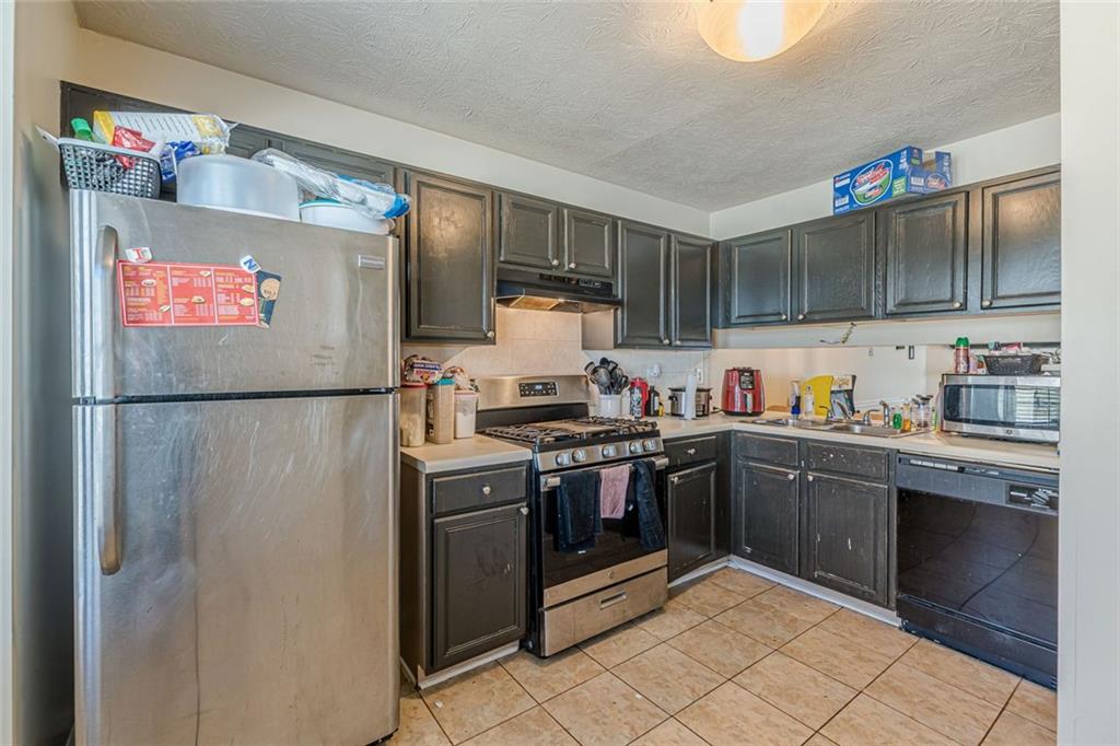 3477 Kingswood Trail Decatur, GA 30034 - Photo 27 of 44 a kitchen with stainless steel appliances granite countertop a sink stove and cabinets